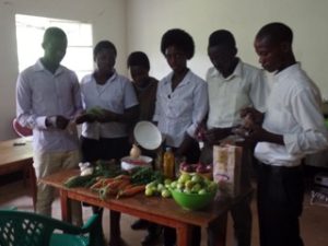 Participants at cooking class, with vegetables